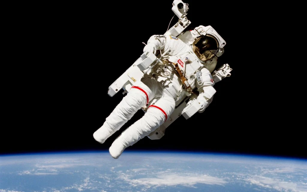 In one of the most iconic space photos of all time, astronaut Bruce McCandless II performs an untethered spacewalk that looks as unreal today as it did in 1984.