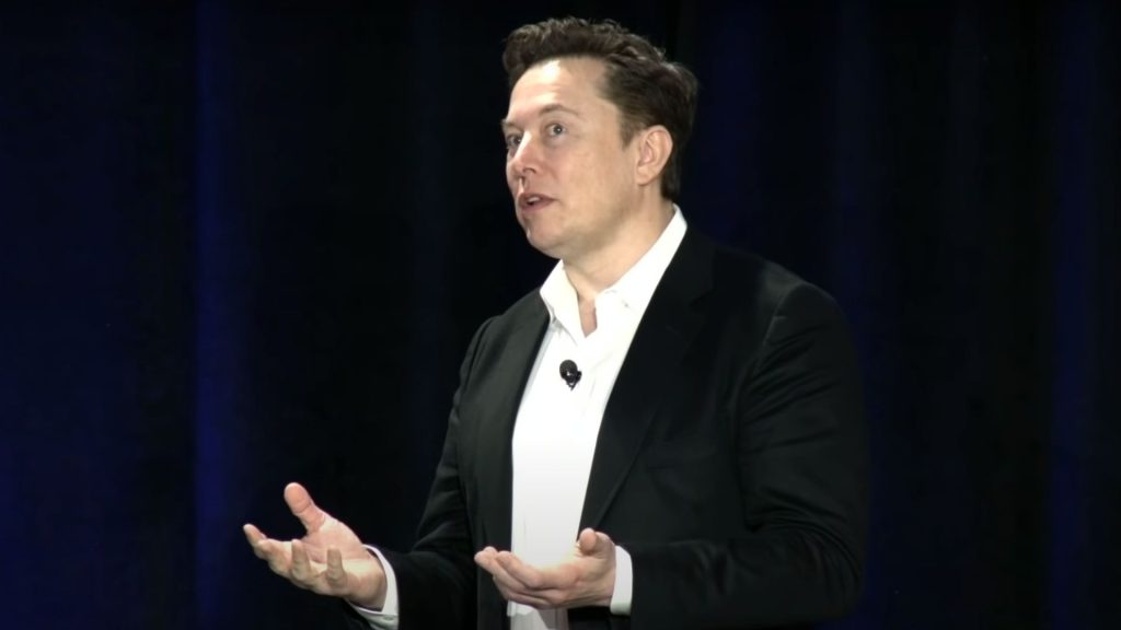 Elon Musk is pictured speaking, Threads