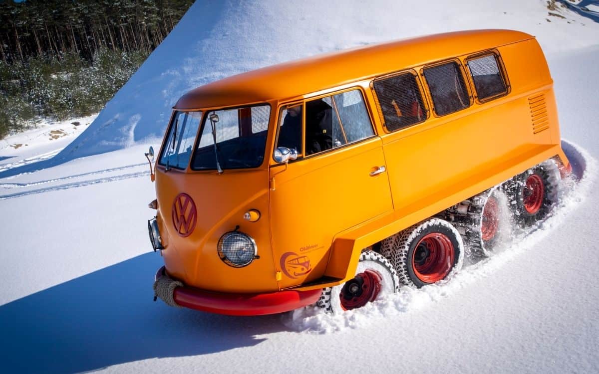 A Kombi van with tank tracks.