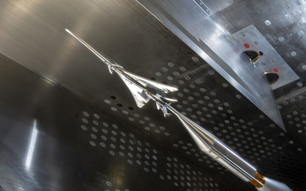 A model of the X-59 in a wind tunnel.