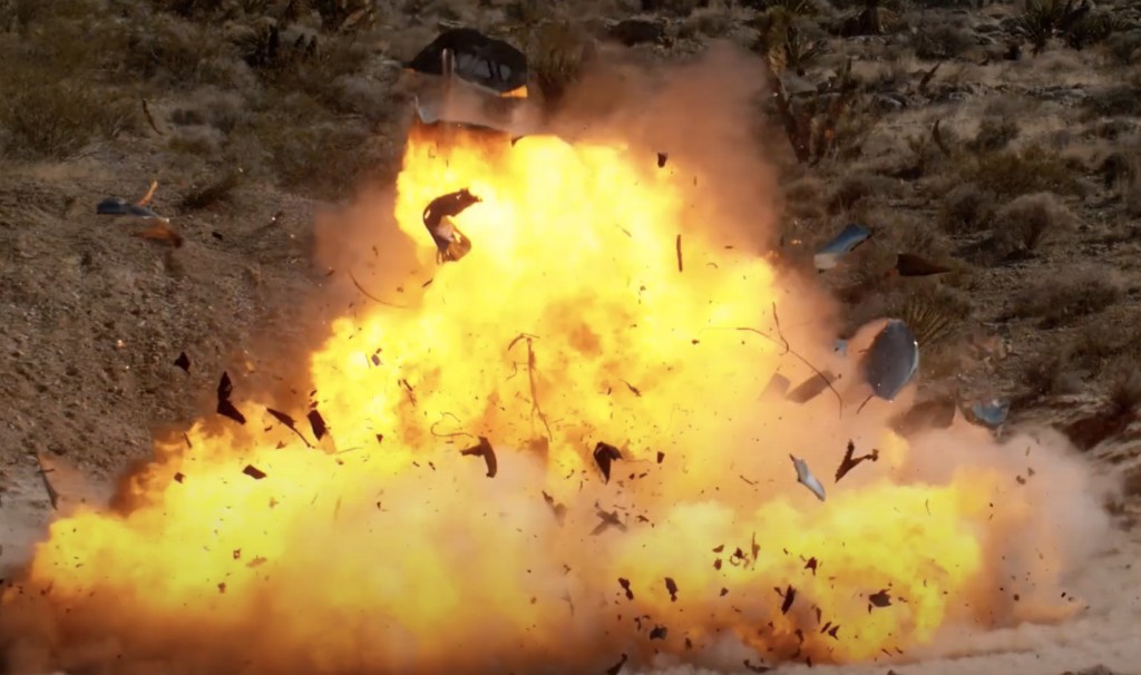 Metal fragments fly outwards from the explosion.