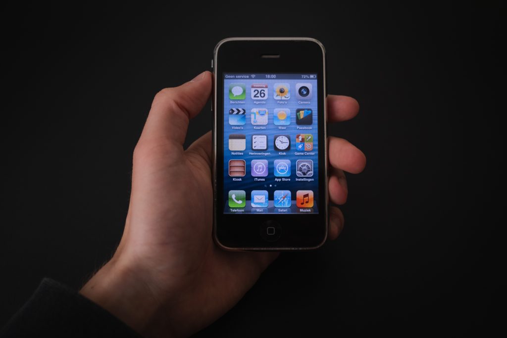 An old iPhone with battery percentage shown. 