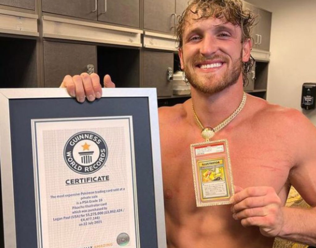 Logan Paul pictured with his Pokemon card and his Guinness World Records certificate.