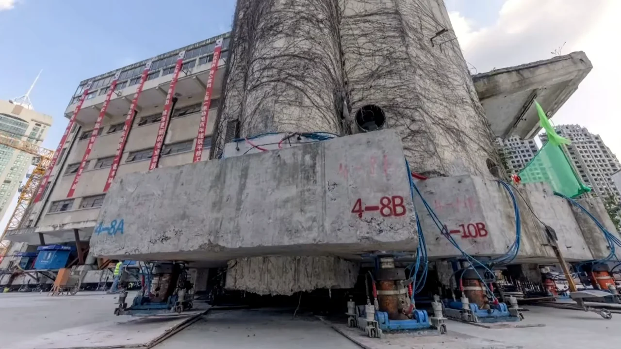An 85-year-old, 7,600-tonne building is relocated 203ft in China using 198 robotic legs