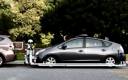 The robot cop slides forward to the car in front.