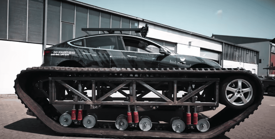 Tank tracks being installed on the Tesla.