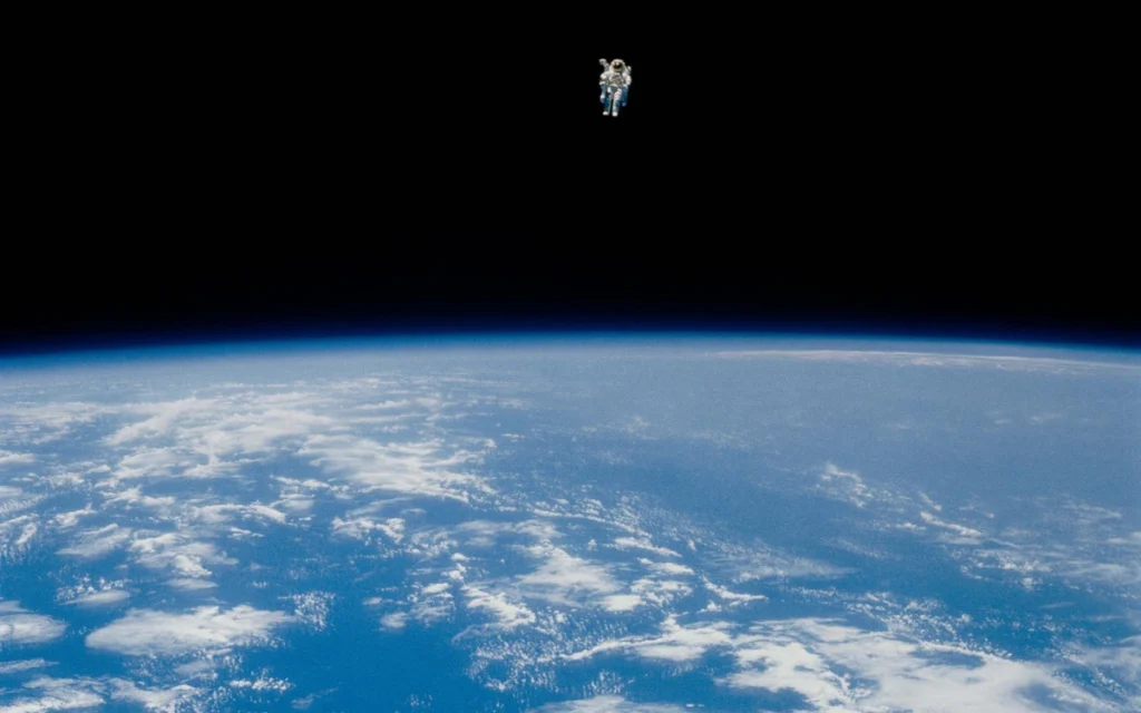 In one of the most iconic space photos of all time, astronaut Bruce McCandless II performs an untethered spacewalk that looks as unreal today as it did in 1984.